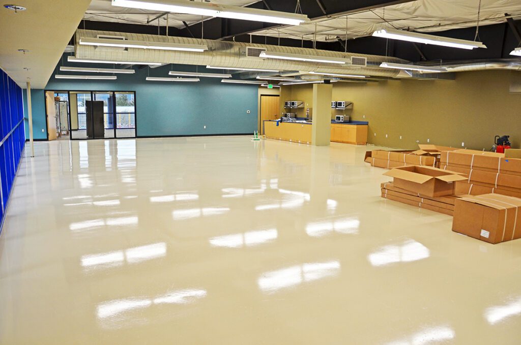 Seamless finish of a newly coated industrial warehouse breakroom floor